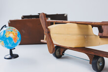Wooden Plane, World Globe, Brown Suitcases. Travel Around The World