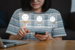 © Deemerwha studio - Women  user using smartphone give rating to service experience on online application for Customer review satisfaction feedback survey concept.