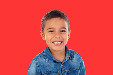 Canvas Print - Latin child with denim shirt looking at camera and laughing