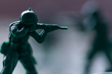 Close-up Of Green Plastic Toy Soldier Aiming Rifle