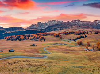 Sticker - Unbelievable autumn sunrise in Alpe di Siusi village with winding country road. Colorful morning scene of Dolomite Alps, Ortisei locattion, Italy, Europe. Traveling concept background..