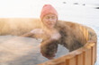 © Westend61 - Relaxed shirtless woman enjoying hot water bath in winter