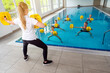 © Kzenon - Teacher or coach in water gymnastics class showing the exercises