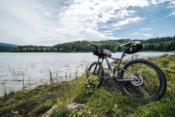 Wall Mural - Bikepacking equipment on a mountain bike. Mountain bike with packed travel gear, bike packing gear ready to ride and camp outdoors.