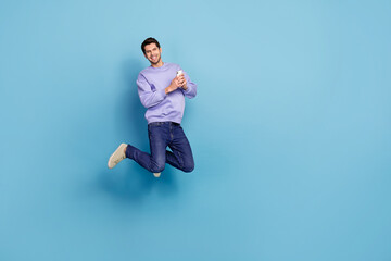 Aufkleber - Photo of millennial blogger guy jump use device enjoy network ads apps isolated pastel blue color background