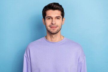 Poster - Photo of good young brunet guy wear sweatshirt isolated on blue color background