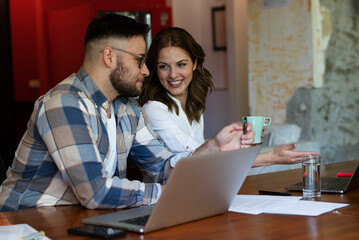 Canvas Print - Colleagues in office. Businesswoman and businessman discussing work in office