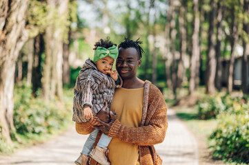 Wall Mural - African american father spending time with his daughter in the park