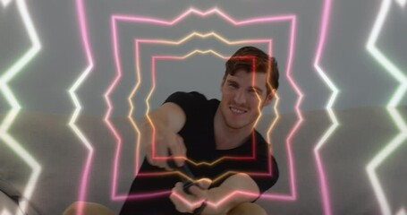 Poster - Animation of tunnel with neon shapes over caucasian man playing video games
