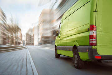 Green delivery truck driving through the city