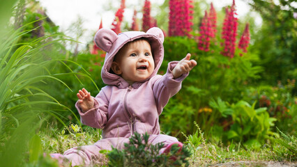 Beautiful happy smiling toddler baby girl wearing a pink hoodie