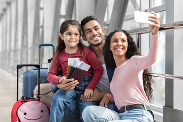 Wall Mural - Airport Selfie . Happy Middle Eastern Family Of Three Taking Photo With Smartphone