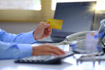 Poster - Man transfers purchases using a credit card and a tablet computer. On his workplace desk
