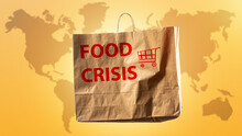 Global Food Crisis. Humanitarian Catastrophe Warning. Lack Of Both Food In Different Countries. Package Labeled Food Crisis In Front Of World Map. Problems With Meal Are Global. Humanitarian Crisis