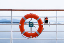 Red Life Buoy. Ring Life Boy On Big Boat.Obligatory Ship Equipment. Orange Lifesaver On The Deck Of A Cruise Ship.