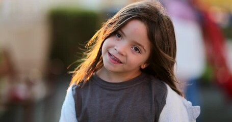 Wall Mural - Adorable little girl portrait face standing outside