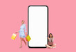 Leinwandbild Motiv Women posing with white empty smartphone screen and shopper bags
