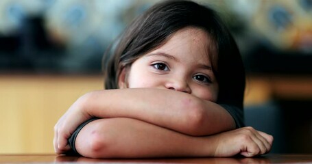 Wall Mural - Small serious child looking at camera little girl arms crossed