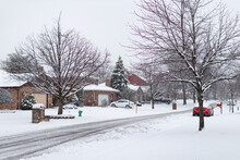 Beautiful Snow Covered Neighborhood Street With Homes During Winter In Suburban Lemont Illinois