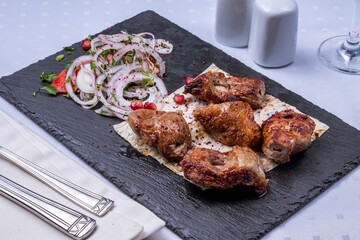 Sticker - skewers of mutton flesh with red onion on black stone plate