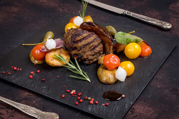 Poster - grilled steak filet Mignon with mini potatoes on dark stone plate