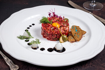 Poster - Tartare from beef with egg on white plate