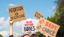 Protesters Holding Signs Abortion Is Healthcare, My Body My Choice, Bans Off Our Bodies, Human Rights. People With Placards Supporting Abortion Rights At Protest Rally Demonstration.