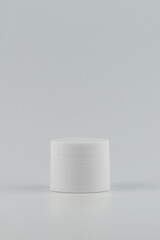 Wall Mural - Unbranded white plastic jar for cosmetics products. Skincare and cosmetology vertical mockup. Branding identity template for text and design