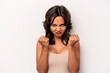 Young hispanic woman isolated on white background upset screaming with tense hands.