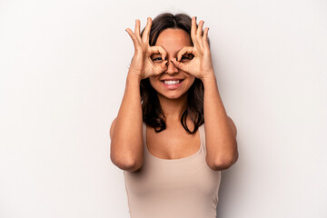 Wall Mural - Young hispanic woman isolated on white background excited keeping ok gesture on eye.