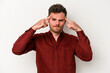 © Asier - Young caucasian man isolated on white background focused on a task, keeping forefingers pointing head.