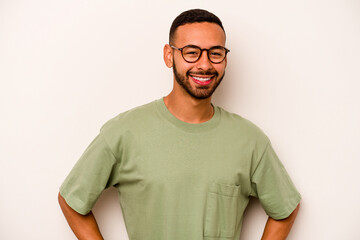 Wall Mural - Young hispanic man isolated on white background happy, smiling and cheerful.