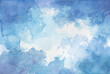 Hand painted watercolor background. Blotches of blue paint with watercolor paper texture grunge. Abstract puffy clouds or sky. 