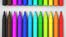 Closeup of colorful markers isolated on white background.