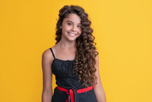 Happy Child With Long Brunette Afro Hair On Yellow Background