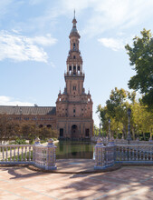 South Tower Of The Plaza De Espana In Seville (Andalusia, Spain). Architectural Structure Built For The Ibero-American Exhibition Of 1929. Fish Pond In Front Of The City's Landmark Building.