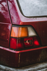 Sticker - Vertical closeup shot of a dirty broken backlight of a red car