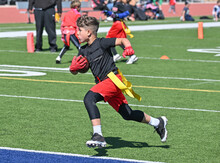 Young Athletic Boy Catching, Running And Throwing The Ball In A Football Game
