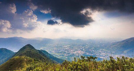 Sticker - Of a natural landscape with mountains and plants, and clouds in the sky