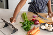 © Wavebreak Media - Midsection of african american mid adult woman watching online recipe while preparing food at home