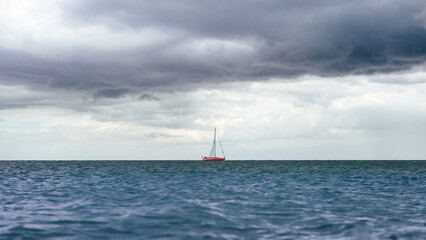 Sticker - Boat in a calm sea under the cloudy sky