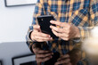 © panitan - using cell phone hand holding mobile texting message contact us.chatting,search internet information in office.technology device communication connecting