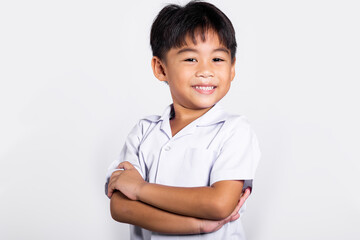 asian toddler smile happy wearing student thai uniform red pants stand with arms folded in studio sh