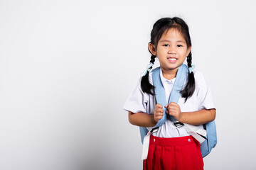 asian adorable toddler smiling happy wearing student thai uniform red skirt standing in studio shot 