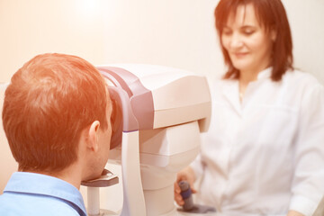 Wall Mural - ophthalmologist doctor in exam optician laboratory with male patient. Men eye care medical diagnostic. Eyelid treatment.