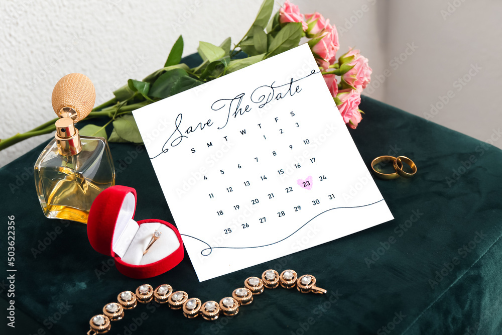 Wedding calendar, rings and female accessories on pouf