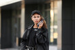 © Pixel-Shot - African-American female security guard with radio transmitter near building outdoors