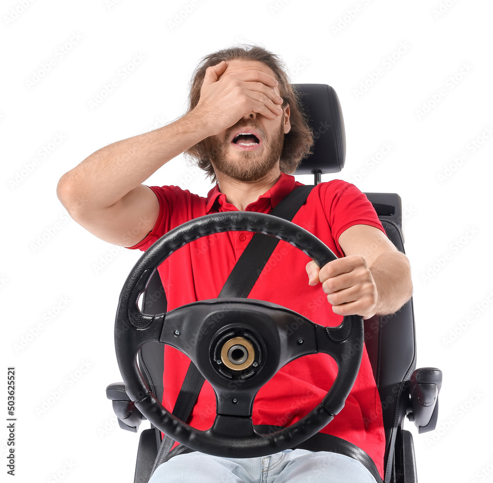 Stressed man in car seat and with steering wheel isolated on white