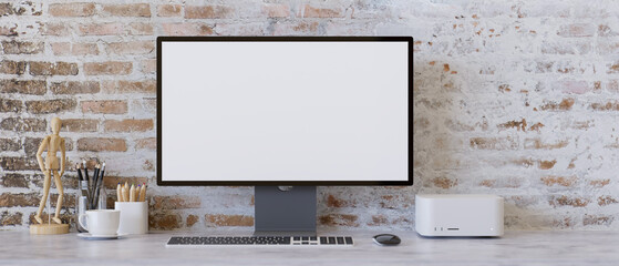 Contemporary workspace design with pc desktop computer on table over vintage brick wall.