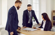 © Studio Romantic - Successful deal. Business people at meeting in office sign contract confirming partnership agreement. Three professional, confident and stylish business partners find compromise sign important deal